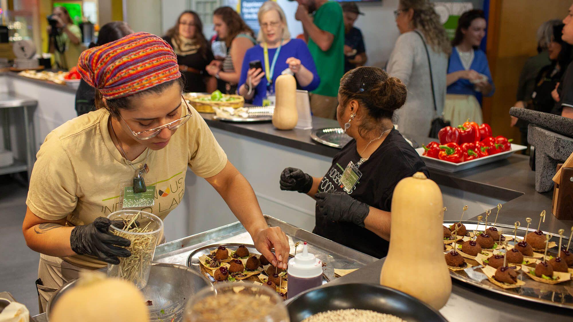 A culinary team prepares samples of Spirit Kitchen dishes for the IFL Market opening party.
Photo: Antonio Collodoro @ NATIFS