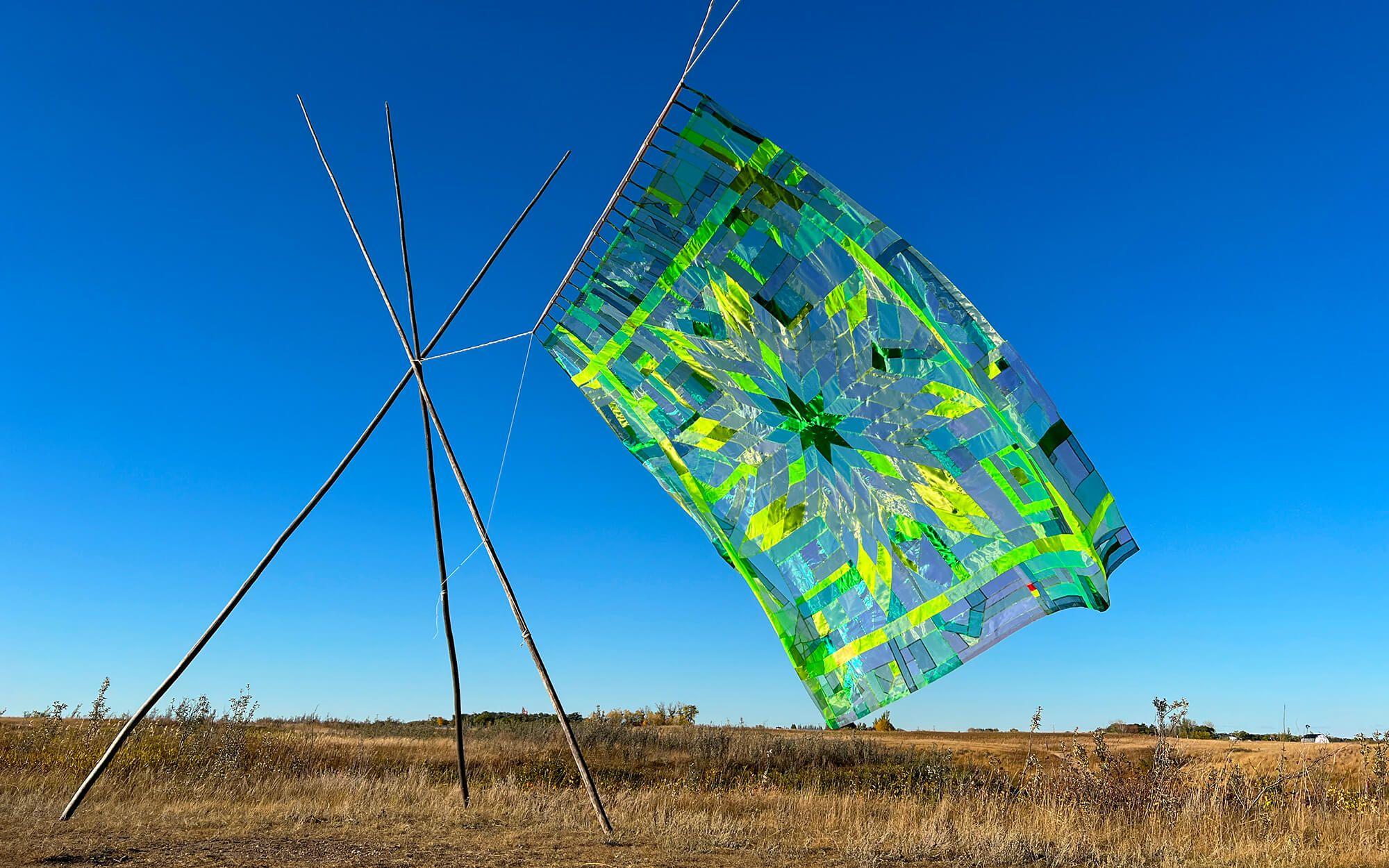 Wally’s quilts wave in the fields on a breezy day, sometimes with Wally holding them high on horseback. For Wally, these quilts are best represented when they’re displayed in nature.
Photo: Wally Dion