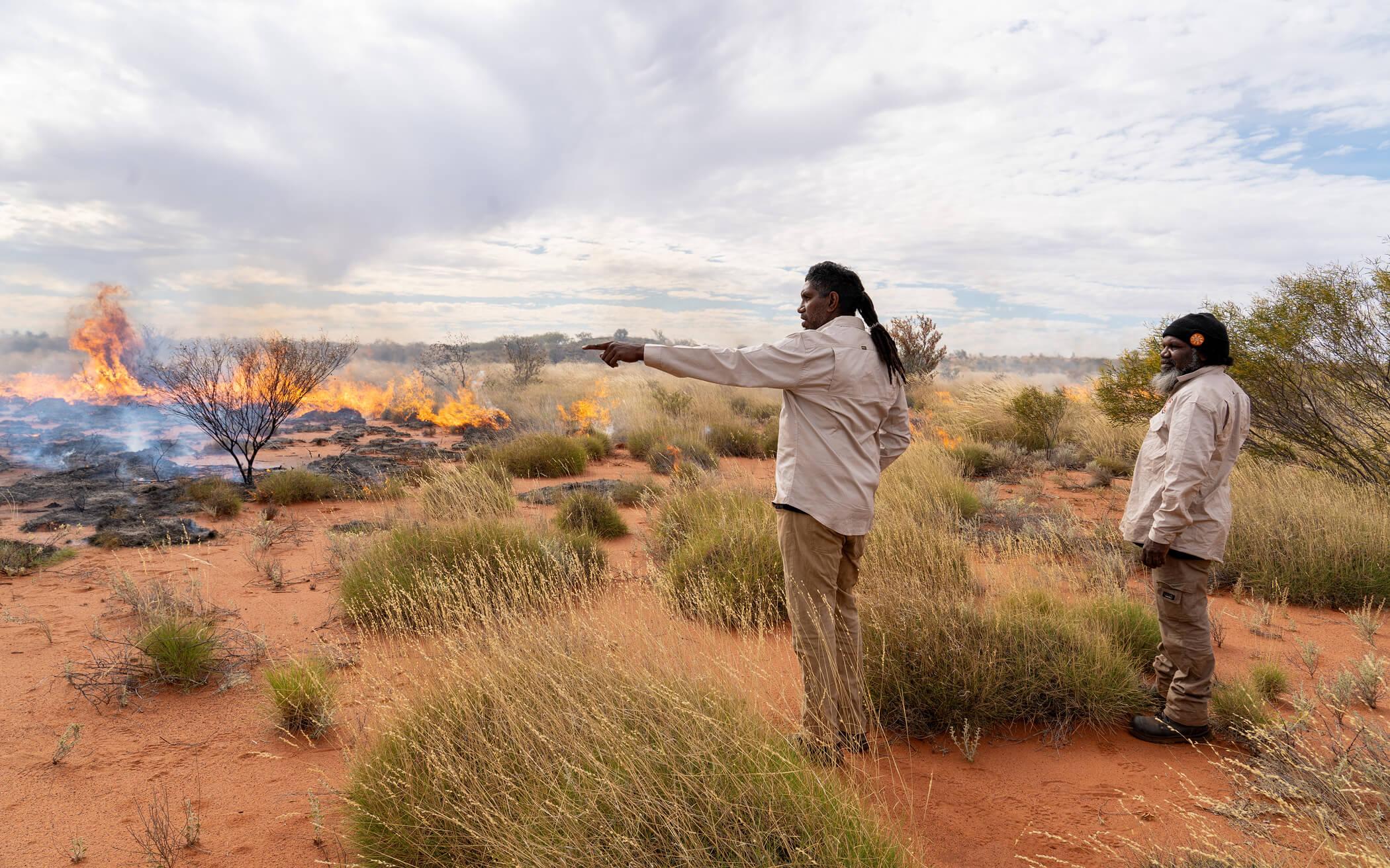 Two rangers examine a controlled burning.
Photo: Kanyirninpa Jukurrpa