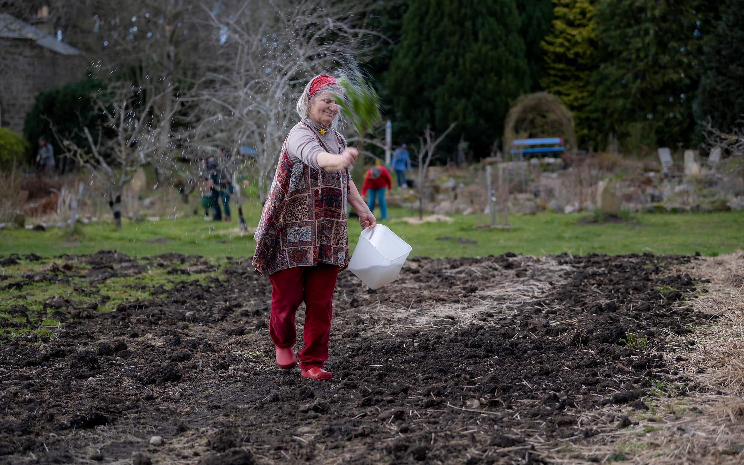 A community member spreads seeds at the Findhorn Ecovillage Cullerne Equinox Ritual.
Photo: Mark Richards - AuroraFindhorn