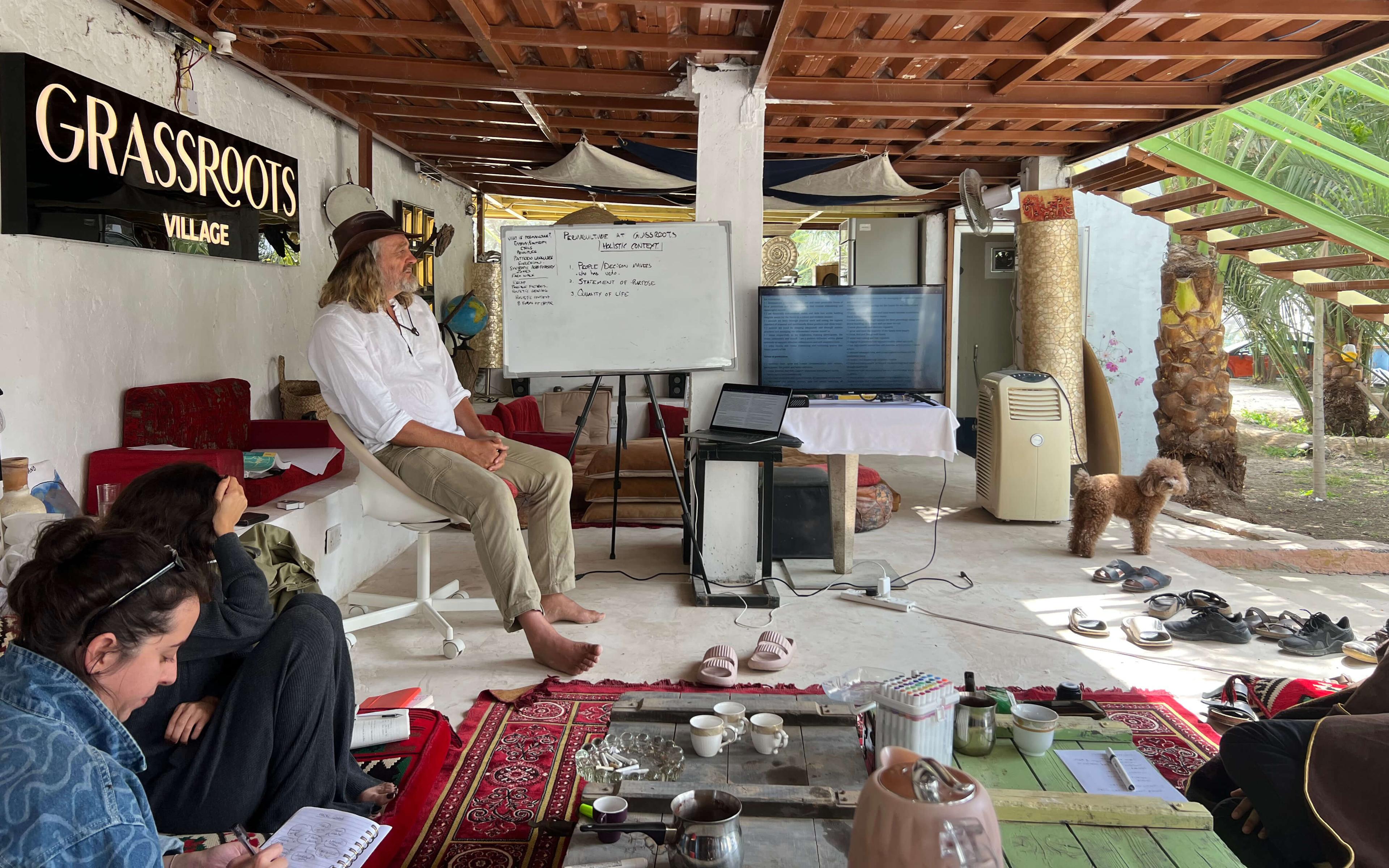 Community members gather to discuss the day at Grassroots Village.
Photo: Grassroots Village