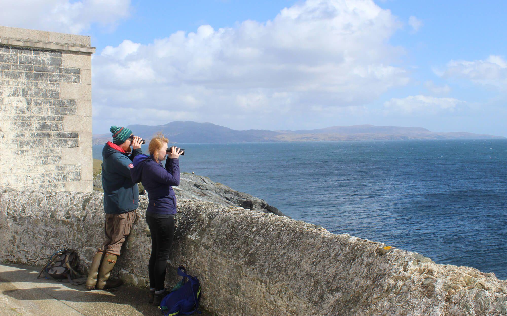 Two volunteers look for signs of whales and dolphins in the Hebrides, engaging in crucial ‘citizen science.’
Photo: Hebridean Whale and Dolphin Trust